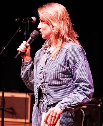 Vrouw met microfoon op podium